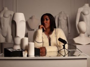 LBJ The Cursive Curator sitting at a desk in fashioni studio